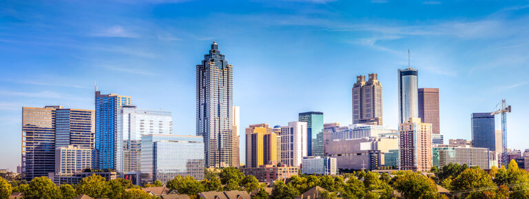 Downtown Atlanta Skyline showing several prominent buildings and hotels under a blue sky